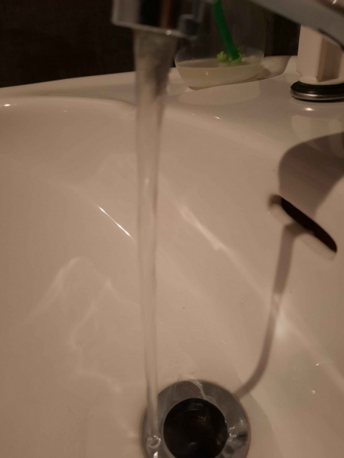 Water jet flowing out of a tap